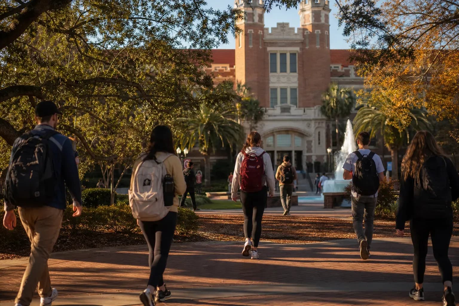 A realistic campus photograph of the iconic landmarks of Florida State University with students walking