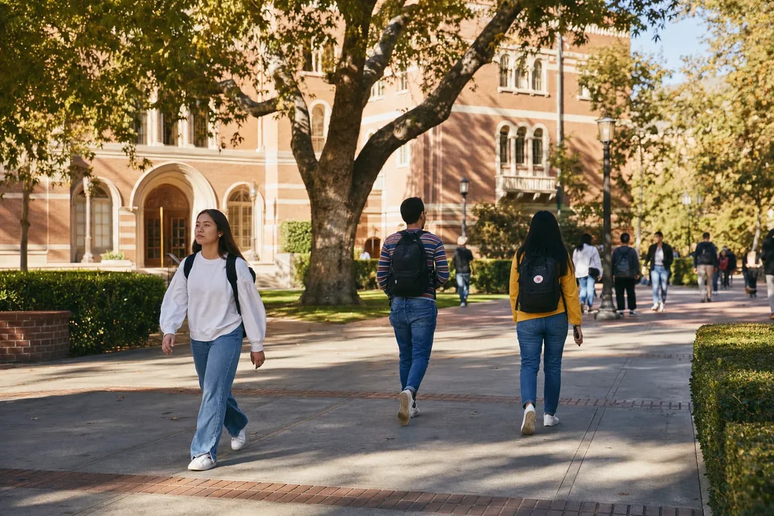 A realistic campus photograph of the iconic landmarks of USC with students walking